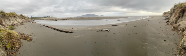 View of Waimeha Stream’s position on Waikanae Beach, seen from the dune near Field Way and facing west toward the sea, with Kāpiti Island visible on the horizon.