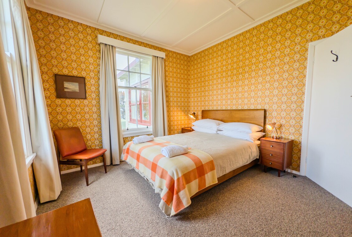 A bedroom in the Lightkeeper's Cottage with a queen bed