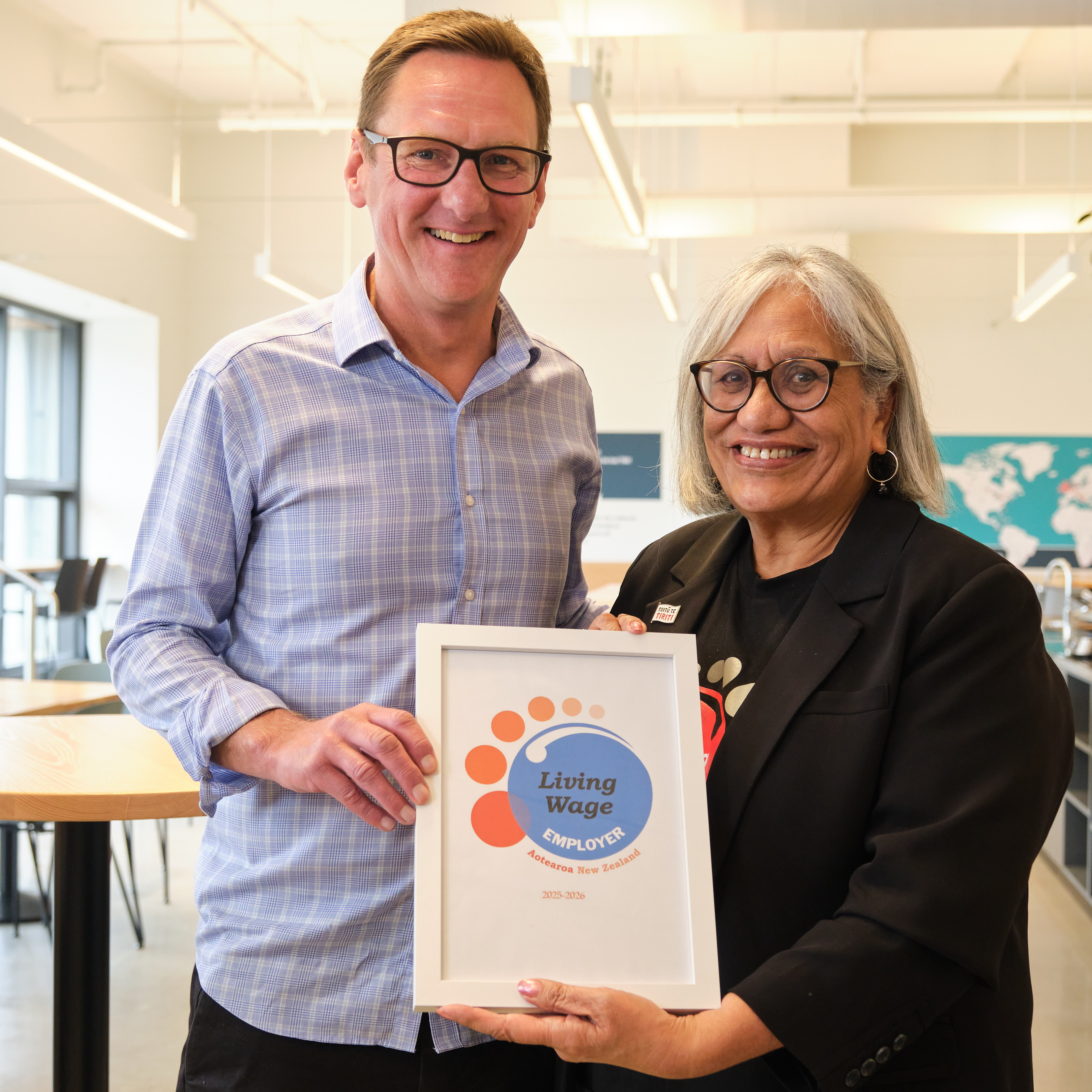 Chief executive Nigel Corry and Living Wage Aotearoa national chair Muriel Tunoho holding the certificate of accreditation
