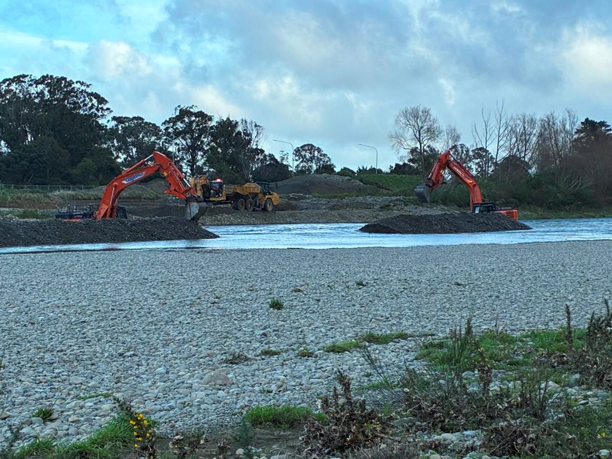 Diggers working on the shore of Te Awa Kairangi/Hutt River 