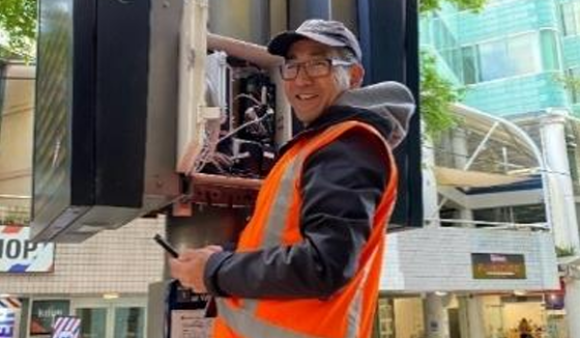 A monitoring officer checks the black carbon monitoring site on Manners Street